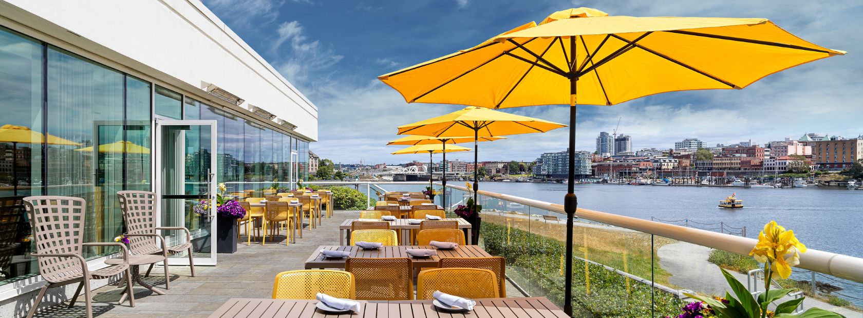 Aura Restaurant's Patio with yellow umbrellas open